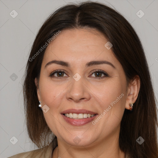 Joyful white adult female with long  brown hair and brown eyes