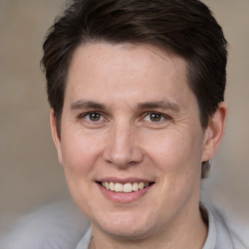 Joyful white young-adult male with short  brown hair and brown eyes