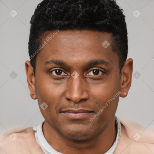 Joyful black young-adult male with short  black hair and brown eyes