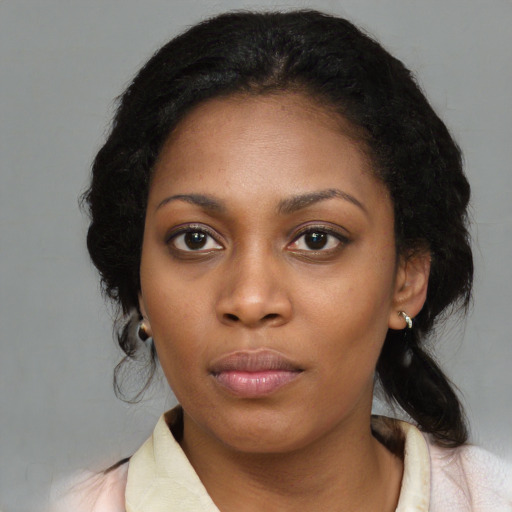 Joyful black young-adult female with medium  black hair and brown eyes
