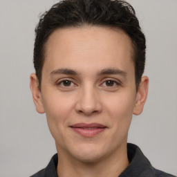 Joyful white young-adult male with short  brown hair and brown eyes