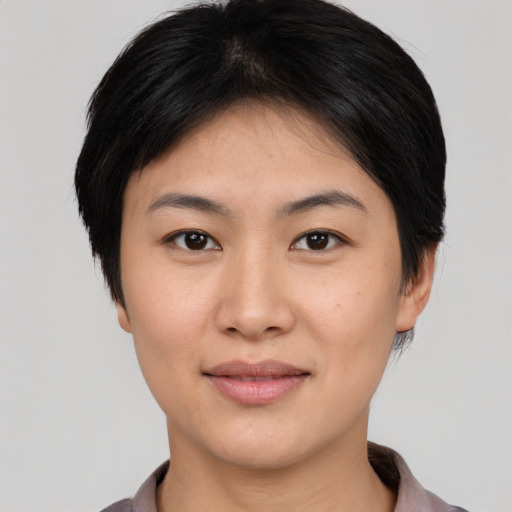 Joyful asian young-adult female with short  brown hair and brown eyes