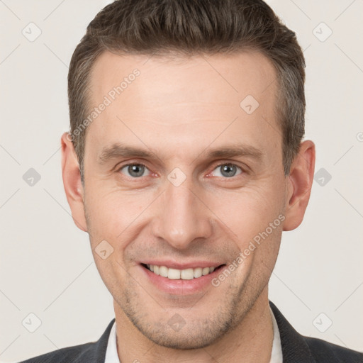 Joyful white adult male with short  brown hair and brown eyes