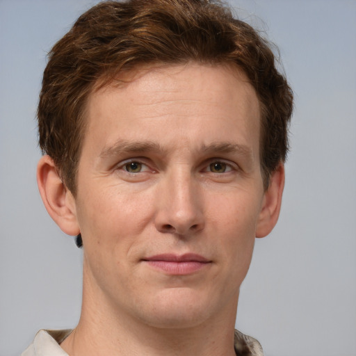 Joyful white adult male with short  brown hair and grey eyes