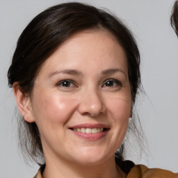 Joyful white adult female with medium  brown hair and brown eyes