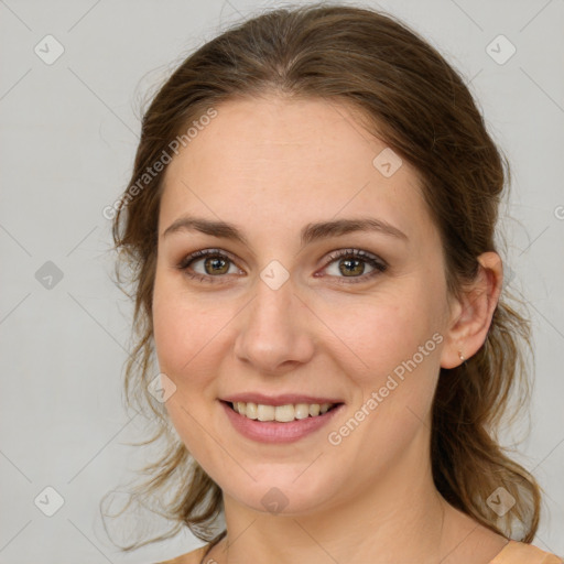 Joyful white young-adult female with medium  brown hair and green eyes