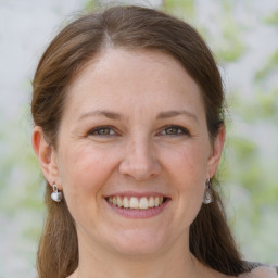 Joyful white adult female with medium  brown hair and brown eyes