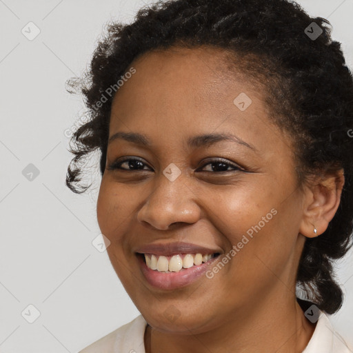 Joyful black young-adult female with short  brown hair and brown eyes