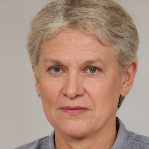 Joyful white middle-aged female with short  brown hair and blue eyes