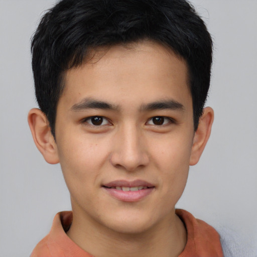 Joyful asian young-adult male with short  brown hair and brown eyes