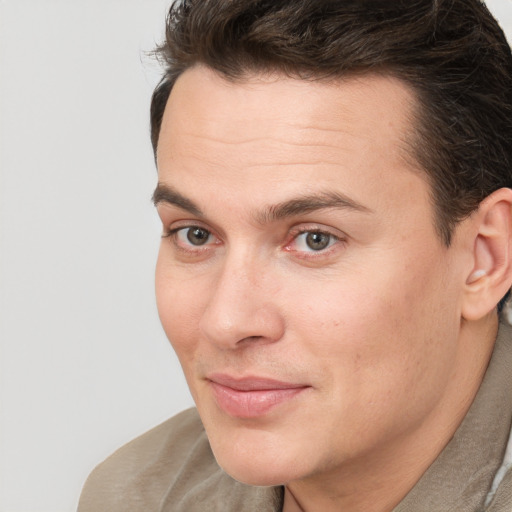 Joyful white young-adult male with short  brown hair and brown eyes