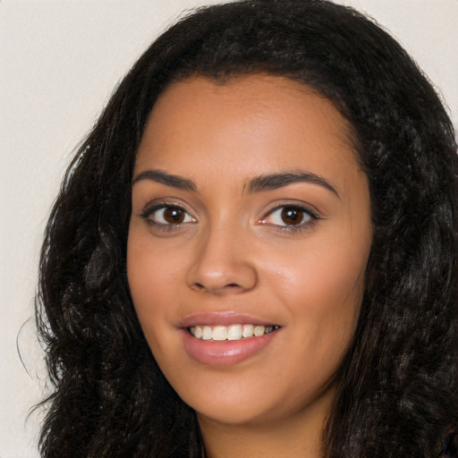 Joyful latino young-adult female with long  black hair and brown eyes