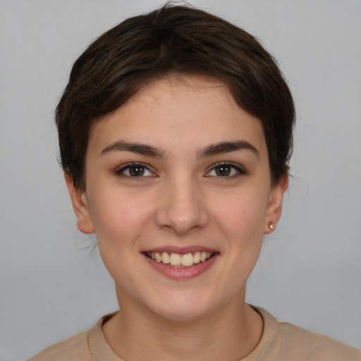 Joyful white young-adult female with short  brown hair and brown eyes