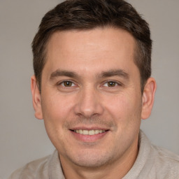 Joyful white young-adult male with short  brown hair and brown eyes