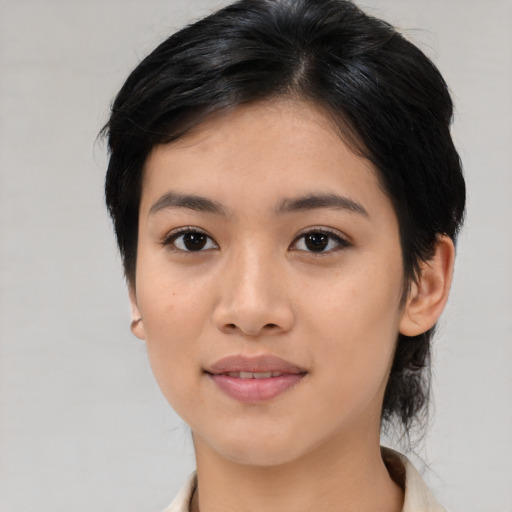 Joyful asian young-adult female with medium  black hair and brown eyes