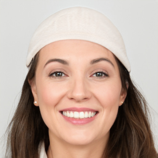 Joyful white young-adult female with long  brown hair and grey eyes