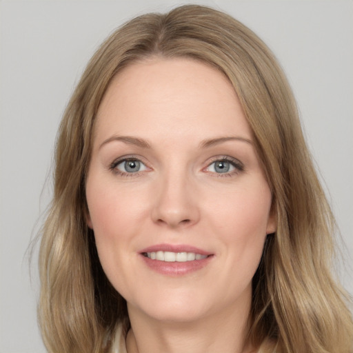 Joyful white adult female with long  brown hair and grey eyes