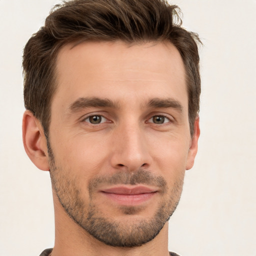 Joyful white young-adult male with short  brown hair and brown eyes