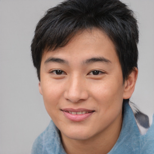 Joyful asian young-adult male with short  brown hair and brown eyes