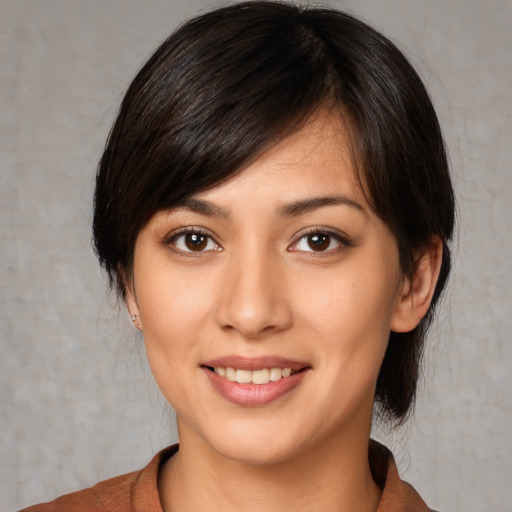 Joyful white young-adult female with medium  black hair and brown eyes