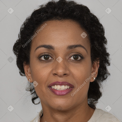 Joyful black adult female with short  brown hair and brown eyes