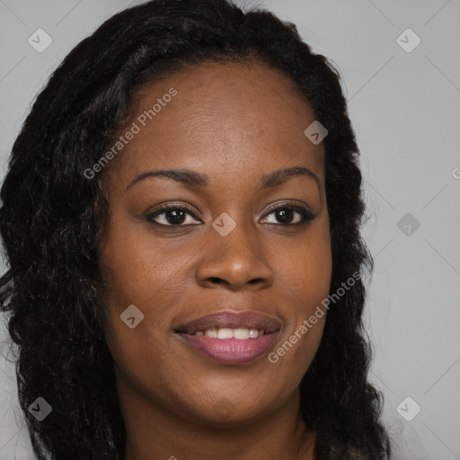 Joyful black young-adult female with long  brown hair and brown eyes