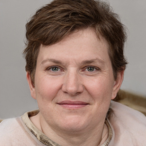 Joyful white adult female with short  brown hair and grey eyes