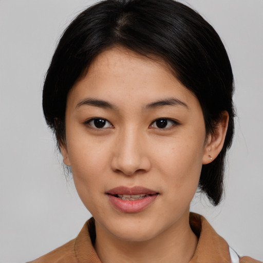 Joyful latino young-adult female with medium  brown hair and brown eyes