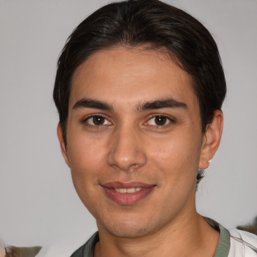 Joyful white young-adult male with short  brown hair and brown eyes