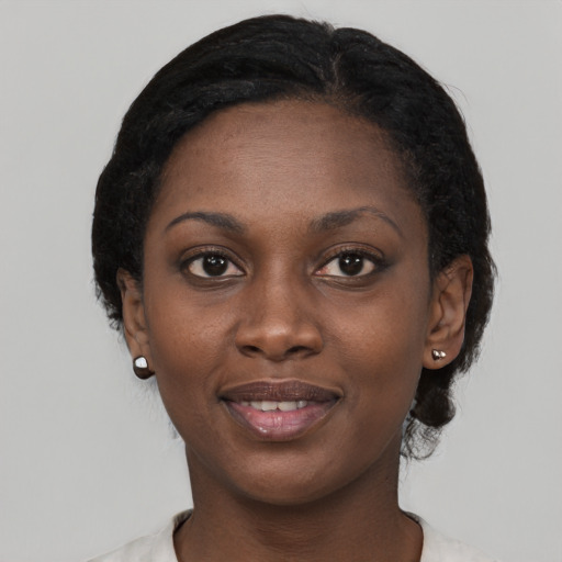 Joyful black young-adult female with short  black hair and brown eyes