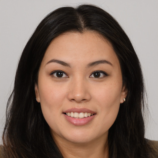 Joyful asian young-adult female with long  brown hair and brown eyes