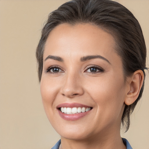 Joyful white young-adult female with medium  brown hair and brown eyes