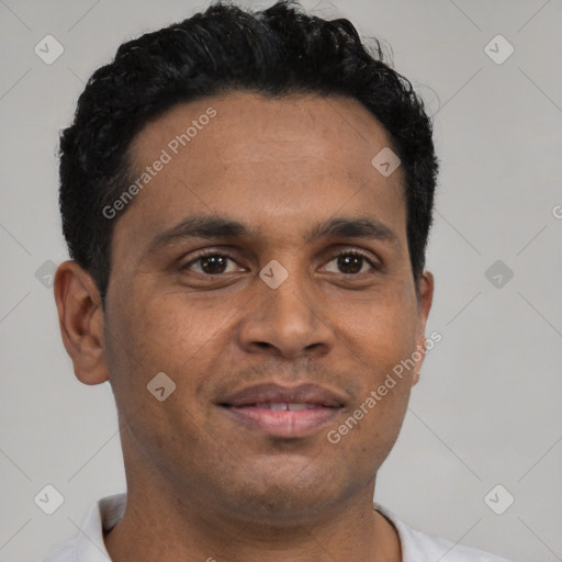 Joyful latino young-adult male with short  brown hair and brown eyes