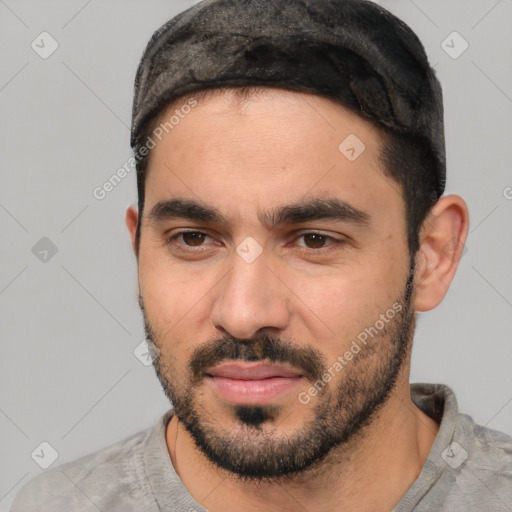 Joyful white young-adult male with short  black hair and brown eyes