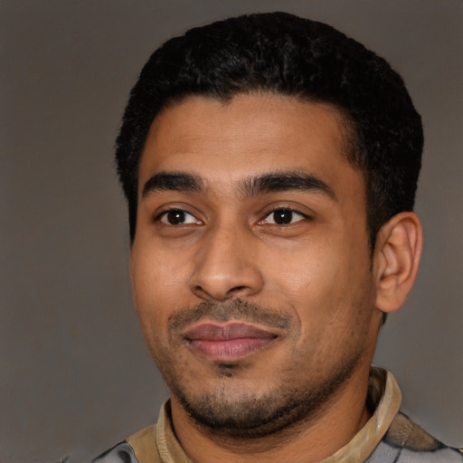 Joyful latino young-adult male with short  black hair and brown eyes