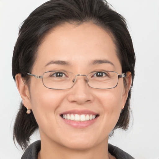 Joyful white adult female with medium  brown hair and brown eyes