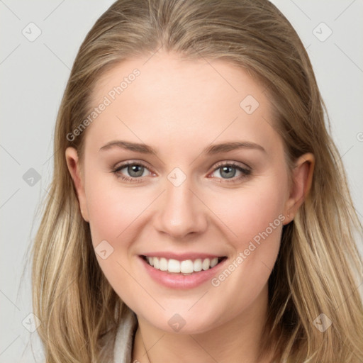 Joyful white young-adult female with long  brown hair and blue eyes