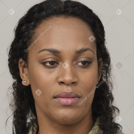 Joyful black young-adult female with long  brown hair and brown eyes