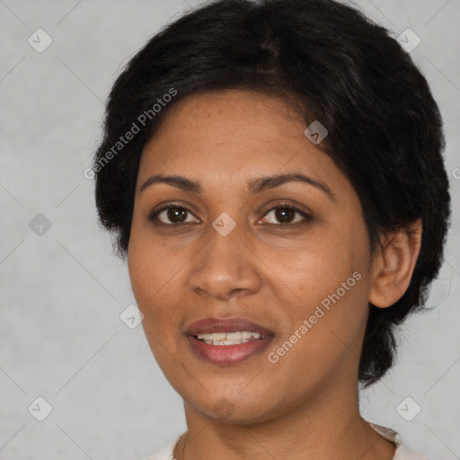 Joyful black adult female with medium  brown hair and brown eyes