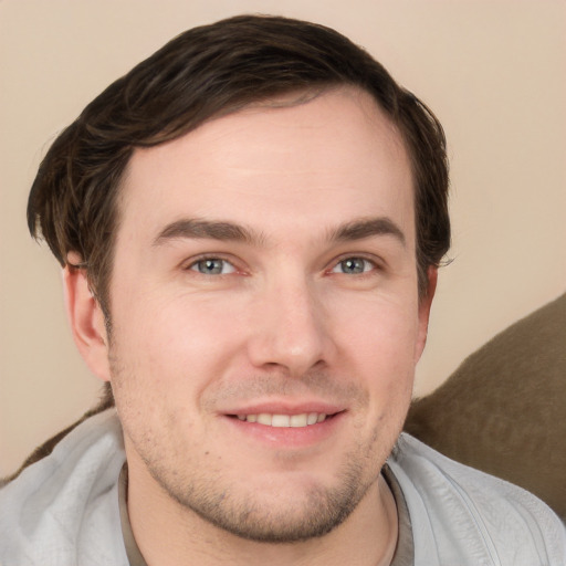 Joyful white young-adult male with short  brown hair and grey eyes