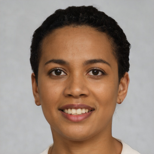 Joyful latino young-adult female with short  black hair and brown eyes
