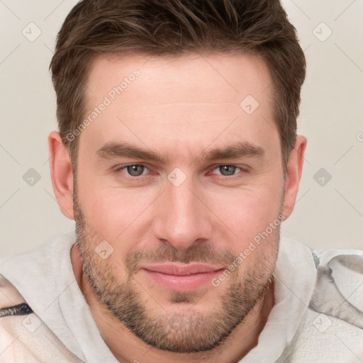 Joyful white young-adult male with short  brown hair and grey eyes