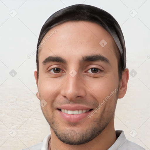 Joyful white young-adult male with short  black hair and brown eyes