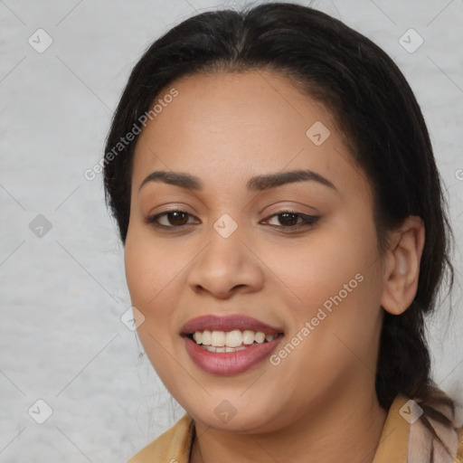 Joyful latino young-adult female with medium  brown hair and brown eyes