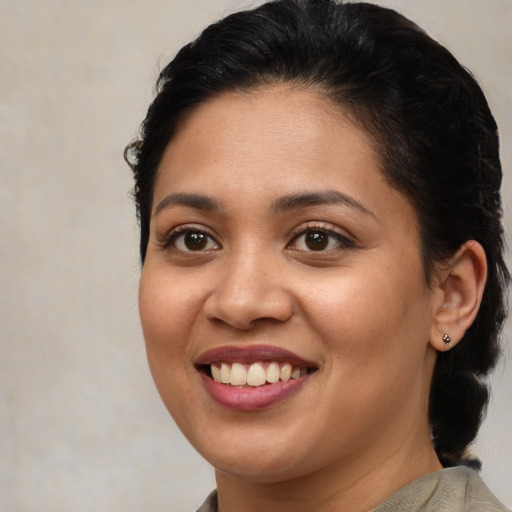 Joyful latino young-adult female with short  brown hair and brown eyes