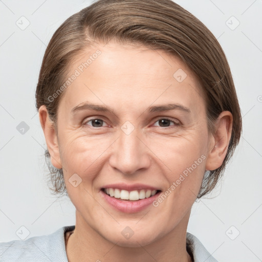 Joyful white adult female with medium  brown hair and grey eyes