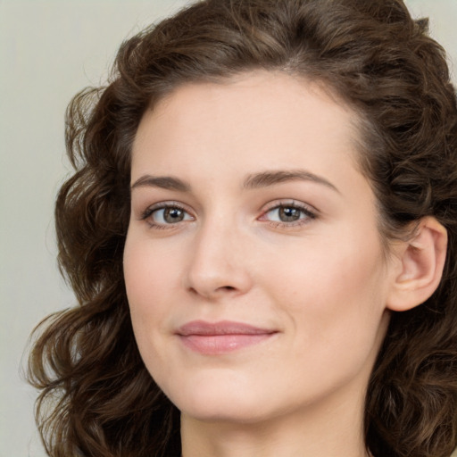 Joyful white young-adult female with medium  brown hair and green eyes