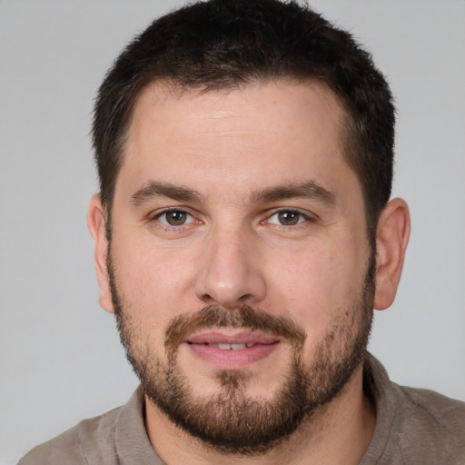 Joyful white young-adult male with short  brown hair and brown eyes