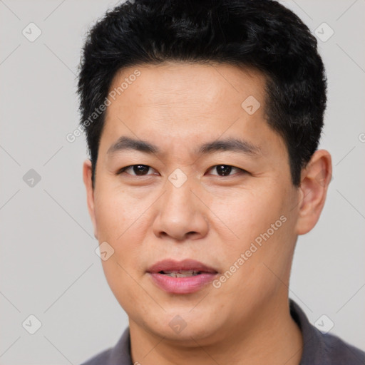 Joyful asian young-adult male with short  black hair and brown eyes