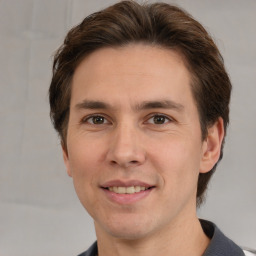 Joyful white adult male with short  brown hair and brown eyes